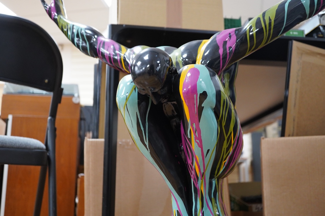 A large contemporary multicoloured composition sculpture of a diver, with mirrored base, 81cm high